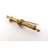 A 9ct gold bar brooch set with pink stone to centre. 1 1/2" wide CONDITION: Please Note -  we do not