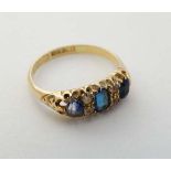 An 18ct gold ring set with blue and whit