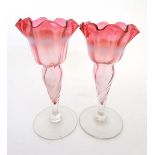 Glass : a pair of late 19thC pedestal glasses with vaseline bad, cranberry bodies, clear glass