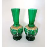 A pair of late 19thC Victorian green glass carafe vases with polychromed enamel decoration and