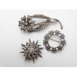 3 various brooches to include a silver and marcasite example , a floral brooch set with paste stones