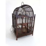 An early - mid 20th Chinese dome topped birdcage with twin glass feeders / drinkers 10 1/2" wide x