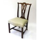 A 19thC mahogany Chippendale style chair with shaped overstuffed seat , carved back rail and top