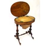 A Victorian inlaid bur walnut inlaid oval sewing table, the top lifting to reveal a lift out