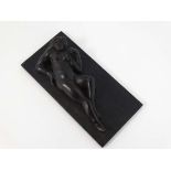 A 19thC carved coromandle plaque with relif image of a naked reclining female 4 3/4" long