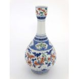 A Chinese porcelain bottle vase decorated with cranes in flight, bats and precious objects in blue