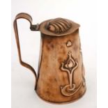 Art Nouveau : A copper hinged lidded jug with embossed decoration with inverted heart and  tulip