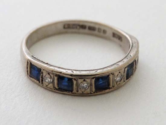 An 18ct gold ring set with 5 sapphires and 4 diamonds  CONDITION: Please Note -  we do not make