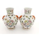 A pair of Chinese Famille-Rose porcelain vases, with Joaiqing mark to base. Painted with butterflies