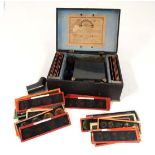 A Magic Lantern; 19th century German boxed tinplate magic lantern with approx 70 slides including