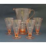 Art Deco : a peach glass conical and partly ribbed lemonade jug with four pedestal matching glasses.