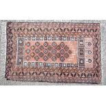 Rug carpet : An Afghan rug, the rose madder mehrab with an overall design of guls, stylised