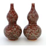 A pair of Chinese banded double gourd vases. With red and green glaze in a Sang du Boeuf and Celadon