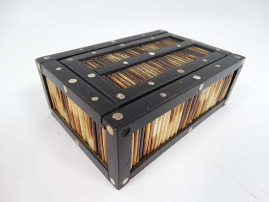 An Indian Porcupine box with sliding lid and inlaid bone discs to the ebony? frame 4 3/4" long