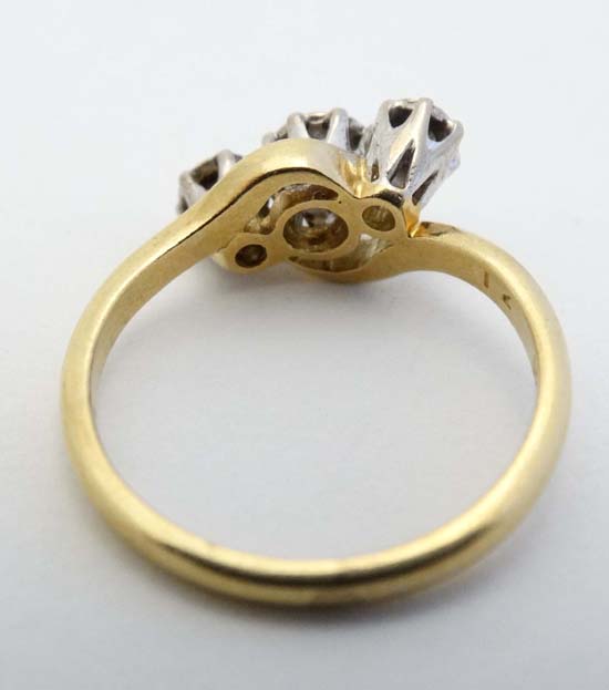 An 18ct gold ring set with trio of diamonds  CONDITION: Please Note -  we do not make reference to - Image 2 of 4