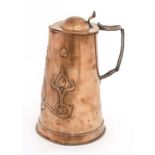 Art Nouveau : A copper hinged lidded bear tankard jug with embossed decoration with heart, tulip