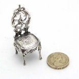 A Victorian miniature silver dolls house chair. Hallmarked London 1899 . 2" high (16g) CONDITION: