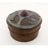 An Art Nouveau composite screw top box with pewter leaf decoration and amethyst coloured cabochon.