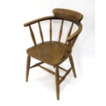 A late Victorian Smoker's Bow chair with double stretcher under elm seat etc. 32" high  CONDITION: