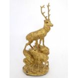 Black Forest : A gilded carved wooden figure group of 2 stags with glass eyes, on  an oval base .