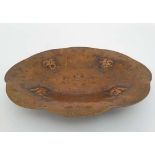 A Continental c.1890 four footed copper dish with repousse embossed flower head decoration and