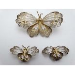 White metal filigree jewellery formed as butterflies  to include a pair of clip earrings and a