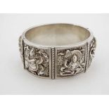 A white metal bangle bracelet decorated with Indian deity decoration  CONDITION: Please Note -  we