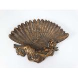 An early 20thC coppered dish in the form of a reclining figure holding a large feather fan . 6 5/