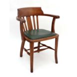 Perkins Brothers & Co - Leicester : An oak open arm office chair with twin stretchers  CONDITION: