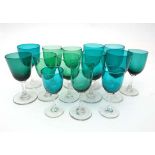 Wine glasses : 14 assorted Victorian Green glass pedestal wine glasses of assorted sizes , some with