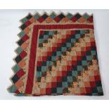 A large vintage hand stitched patchwork quilt with triangle detail board, in creams, reds and