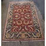 Carpet rug : a deep pile woollen rug with navy blue, burgundy, salmon and fawn colours 106 x 71"