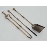 A c1900 brass 3-piece fire tool set comprising poker tongs and shovel . Approx 26 1/2" long