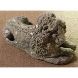 Garden and architectural : an old  composite stone figure of a couchant lion. Has two fixing holes