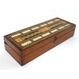 A Victorian Walnut Cribbage box / Scorer having inlaid wood sections and bone to top with 60 pierced