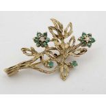 A 9ct gold brooch formed as a floral sprig set with emeralds and diamonds 1 1/" long  CONDITION: