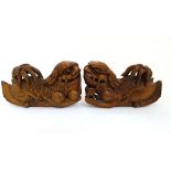 A pair of hardwood carvings of Ying & Yang - a pair of temple dogs , one with a pup, the other Pearl