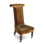 A late 19thC walnut  Prie Dieu chair with velvet upholstery and ring turned supports to sides. 39"