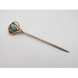 A 9ct gold stick pin with open work decoration to top set with central turquoise  CONDITION: