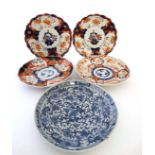 A group of four matched plates in Imari style with blue decoration to underside. 8 1/2'' diameter.