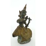 A contemporary Thai bronze figure dancing and holding a flute. 6” high. CONDITION: Please Note -  we
