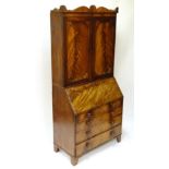 A 19thC flame veneered mahogany bureau bookcase, the top opening to reveal 2 adjustable shelves