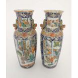 A pair of  hand painted Chinese Famille-Rose vases . Probably Cantonese. Decorated with scenes of
