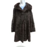 A dark brown ladies fur coat with dark brown lining. Bears label for Fenwick, French Salon,