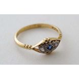 A 18ct gold ring with central sapphire flanked by 2 diamonds in a platinum setting and marked '