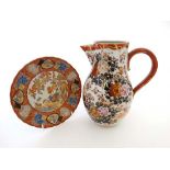 An Oriental Kutani style jug together with a Kutani style plate. c1920s. Both marked to base. Jug