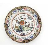 An Ironstone plate decorated in Oriental style. Decorated with floral and foliate detail with