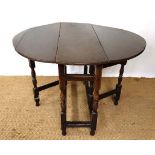 A  c.1700 medium to small sized oak oval drop flap table with twin gate legs 37 1/2" wide