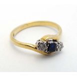 An 18ct gold ring set with central sapphire flanked by 2 diamonds  CONDITION: Please Note -  we do