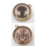 Mourning / Memorial Jewellery : a 19thC circular pendant locket with lock of hair detail one side